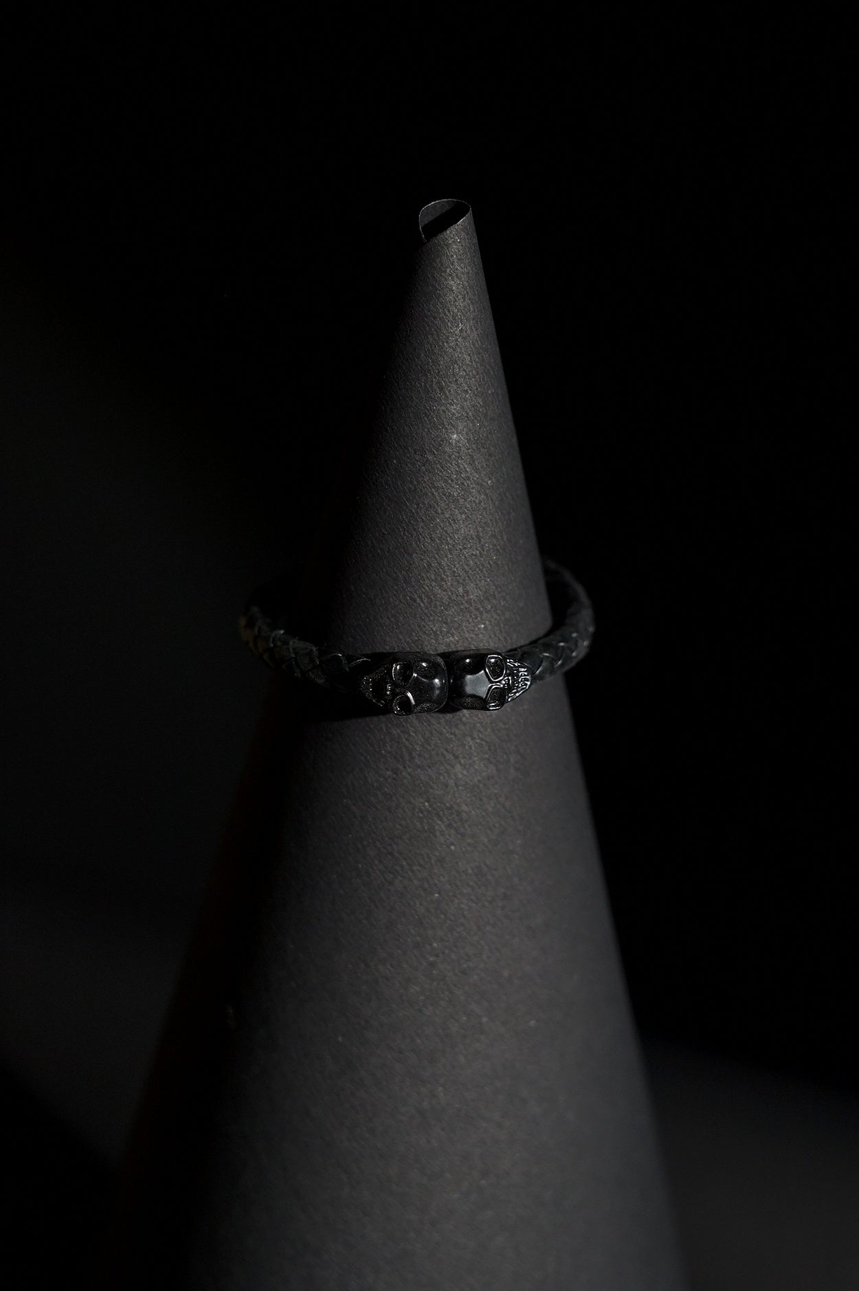 Bracelet | Single Strand | Woven Braided Cord | Black Braided Leather-Look Cord with Dual Black Skull Clasp-Accent | Men & Women | Braided Design | Matte Black Finish | Gothic & Edgy Style