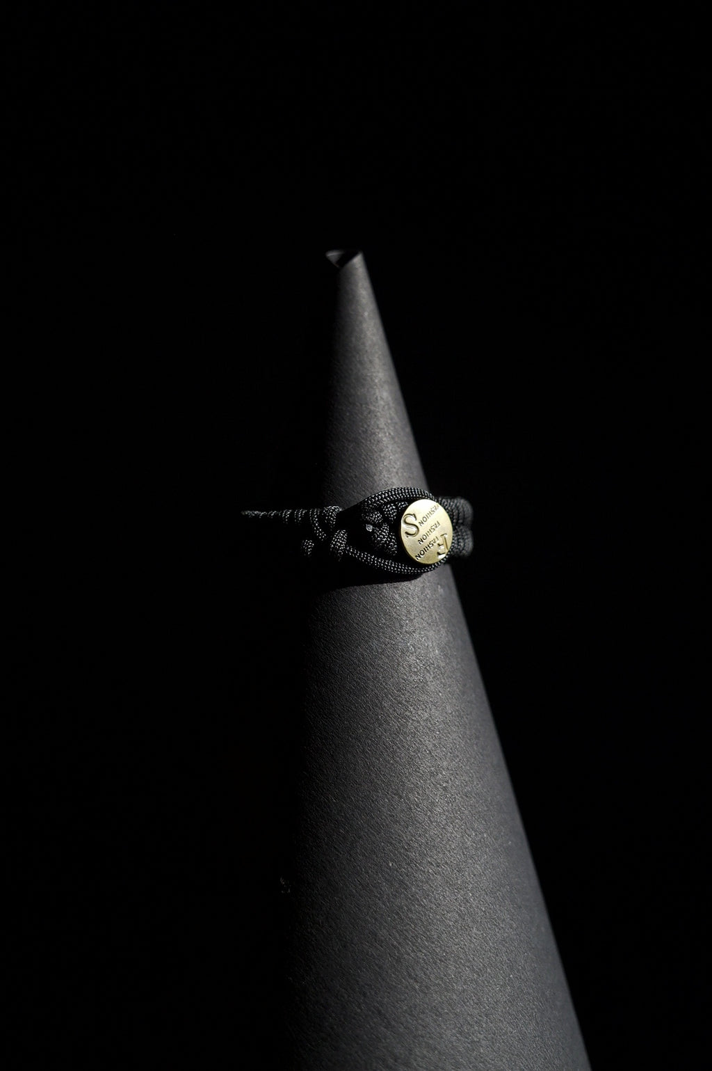 Bracelet | Single Strand | Woven Paracord | Black Knotted Cord | Engraved Disc Accent | Men & Women | Woven Design | Textured Fabric & Gold-Tone Finish | Casual & Nautical Style
