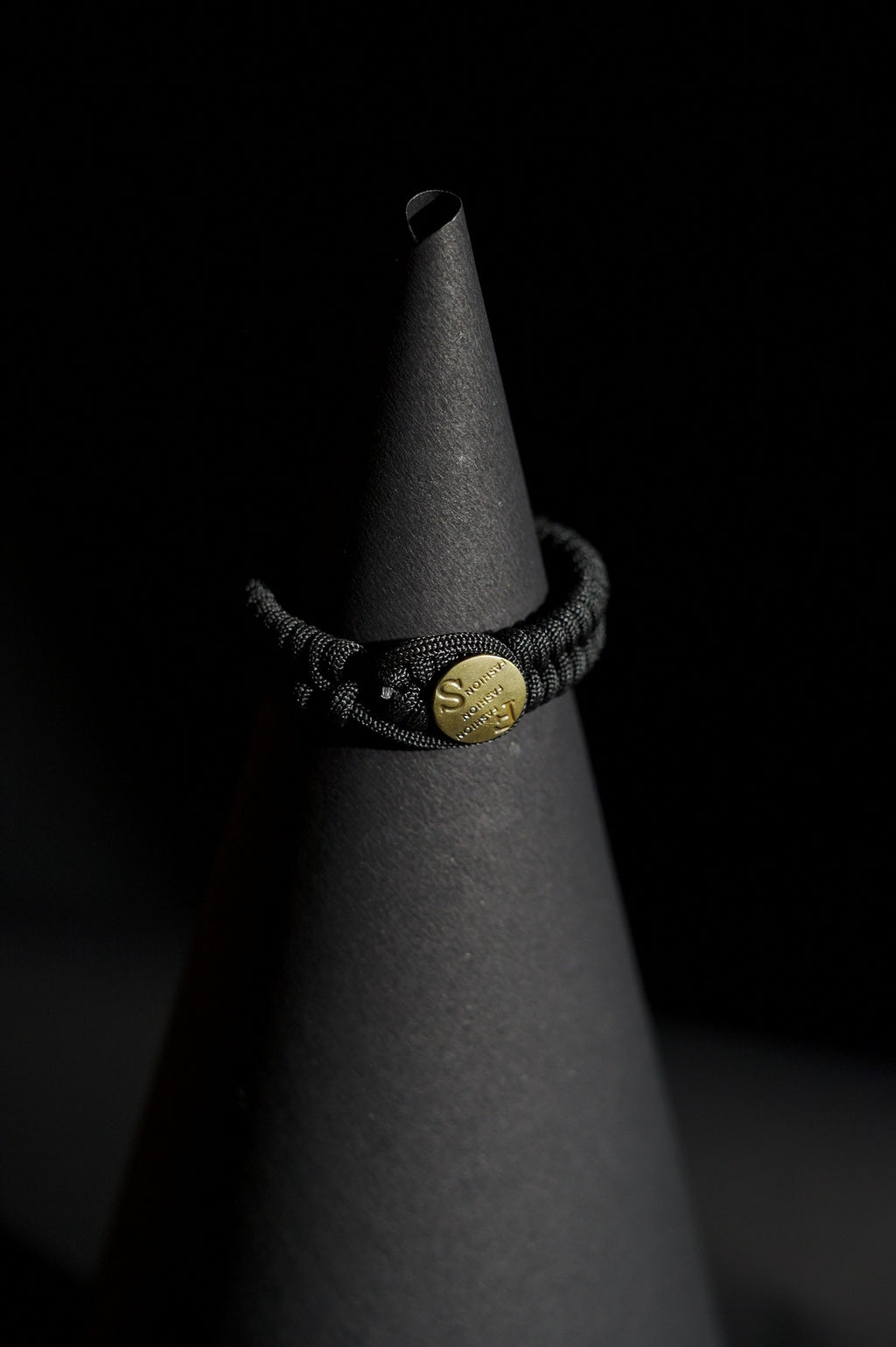 Bracelet | Single Strand | Woven Paracord | Black Knotted Cord | Engraved Disc Accent | Men & Women | Woven Design | Textured Fabric & Gold-Tone Finish | Casual & Nautical Style